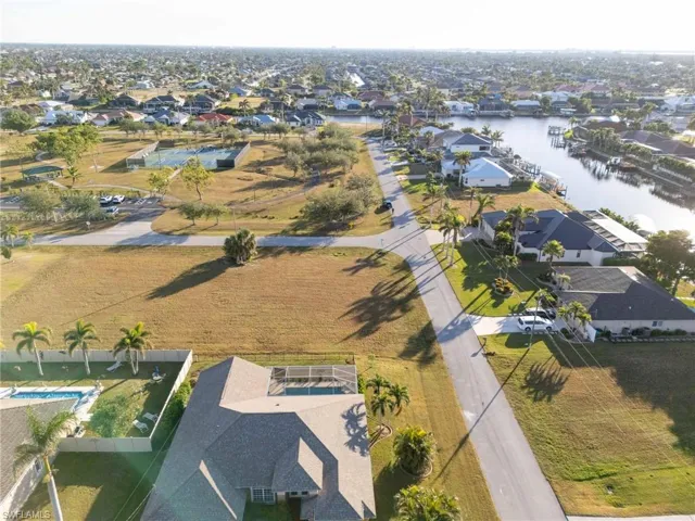 Birds eye view of property with a water view