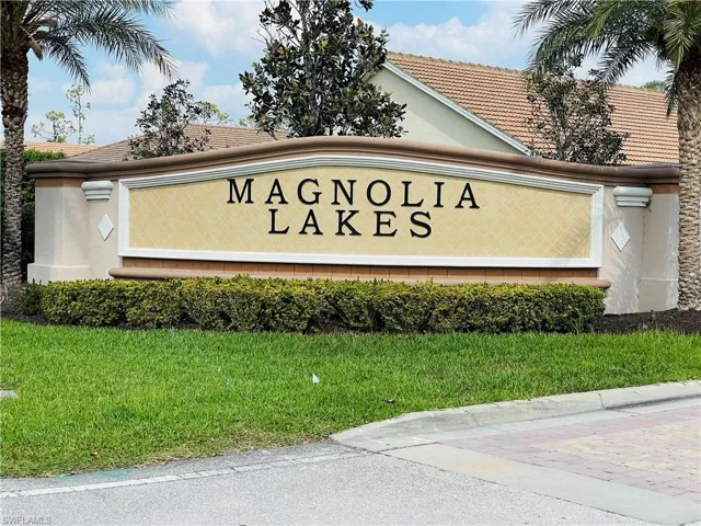 Community / neighborhood sign with a lawn