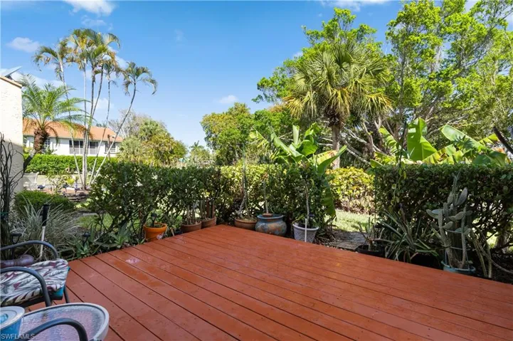 Wooden deck with a fenced backyard