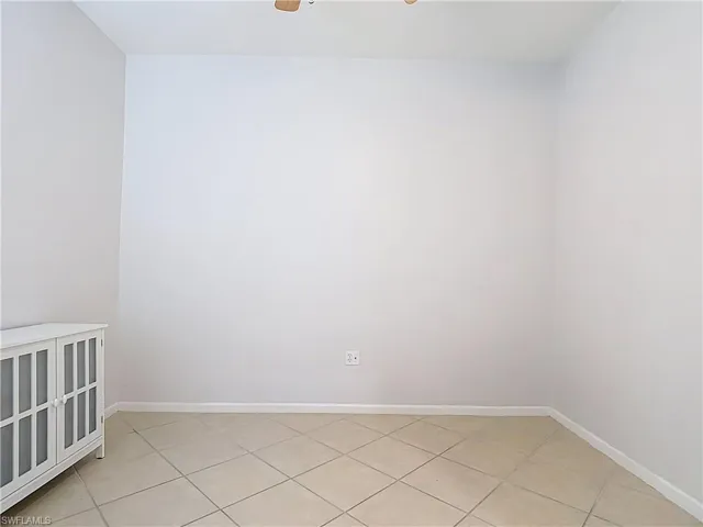 Spare room with ceiling fan and light tile patterned floors