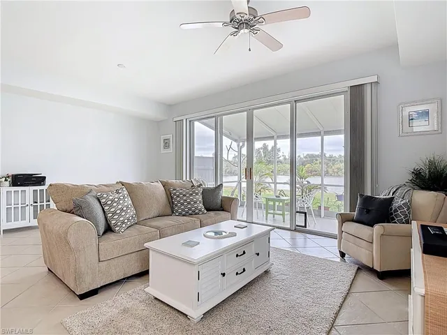 Living room with ceiling fan and light tile patterned floors