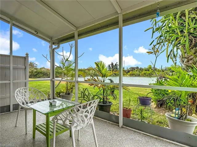 Sunroom / solarium featuring floor to ceiling windows, healthy amount of natural light, and a water view