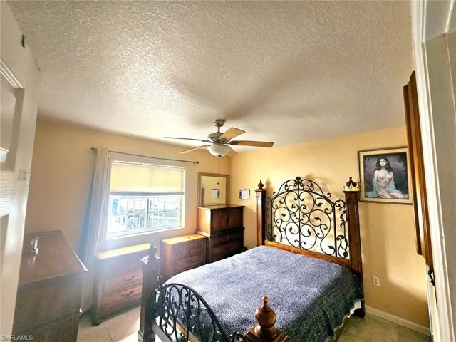 Bedroom featuring a textured ceiling and ceiling fan