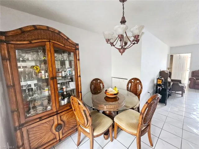 Tiled dining area featuring a chandelier