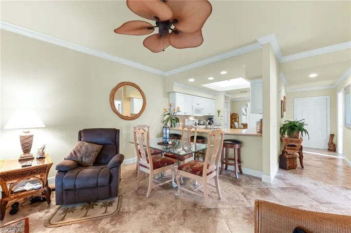 Dining area featuring crown molding and ceiling fan