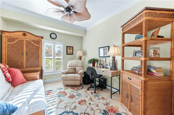 Office space featuring crown molding, wood finished floors, and ceiling fan