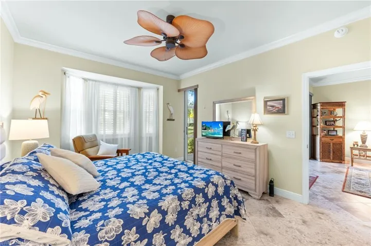 Bedroom with ornamental molding, a ceiling fan, and access to outside