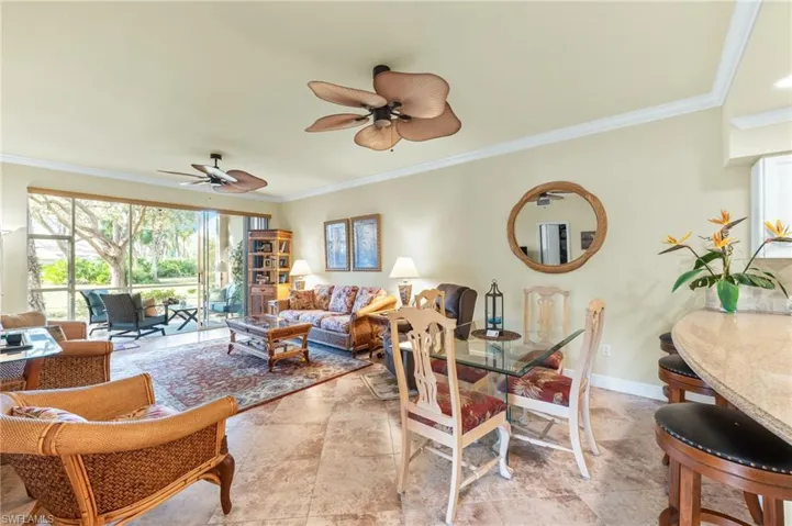 Dining space featuring crown molding and a ceiling fan