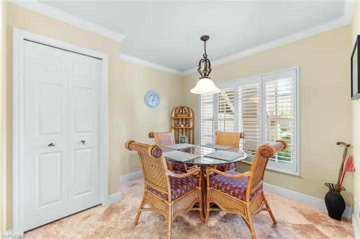 Dining room featuring crown molding and baseboards
