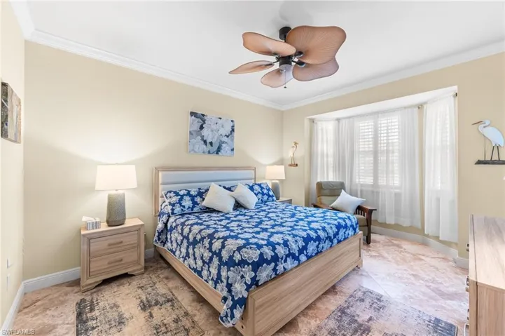Bedroom featuring crown molding and a ceiling fan