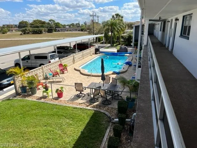 View of swimming pool featuring a yard and a patio