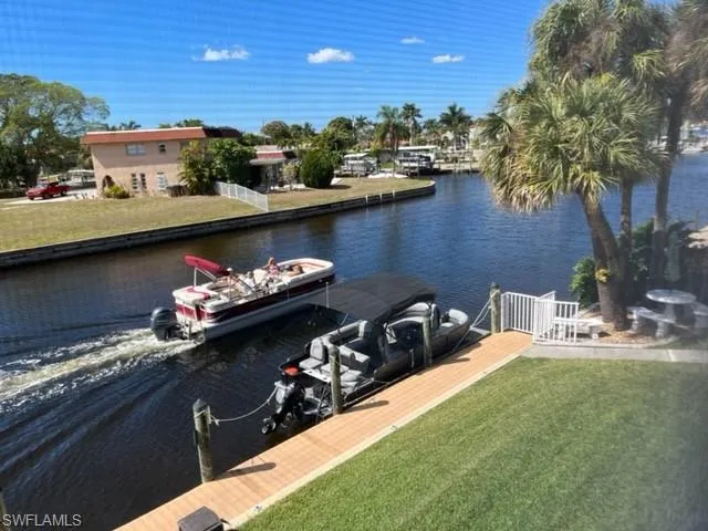 Property view of water with a boat dock