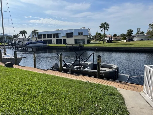 Dock area featuring a yard and a water view