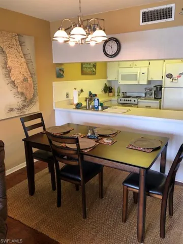 Dining room featuring a notable chandelier and hardwood / wood-style floors