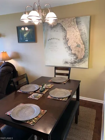 Dining room featuring an inviting chandelier and hardwood / wood-style flooring