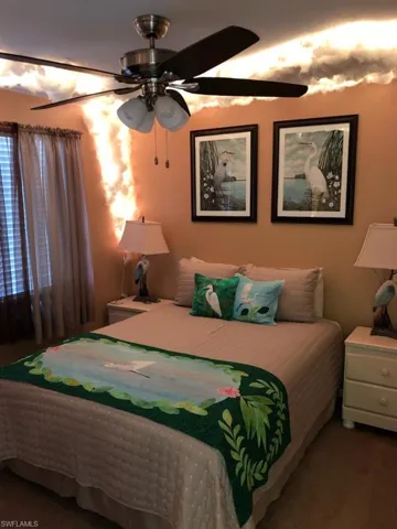 Carpeted bedroom with ceiling fan