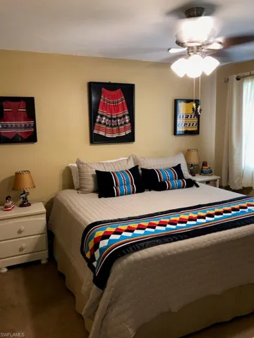 Bedroom with ceiling fan and carpet