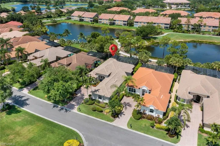 Birds eye view of property with a water view