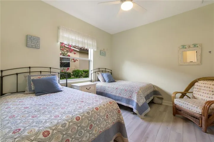 Bedroom featuring ceiling fan and hardwood / wood-style floors