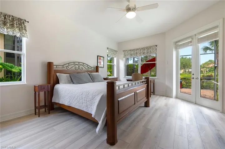 Bedroom featuring multiple windows and light hardwood / wood-style flooring