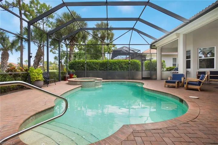View of pool with a patio, a lanai, and an in ground hot tub