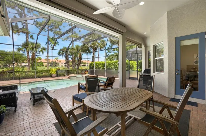 View of patio / terrace with glass enclosure, ceiling fan, and a swimming pool with hot tub