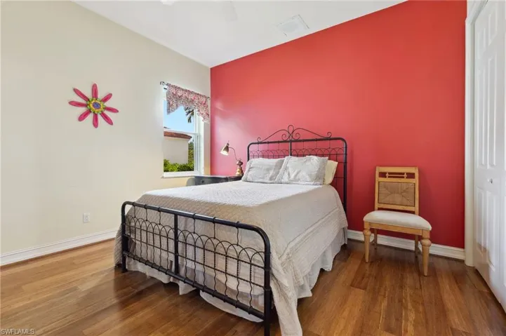 Bedroom with ceiling fan and hardwood / wood-style floors
