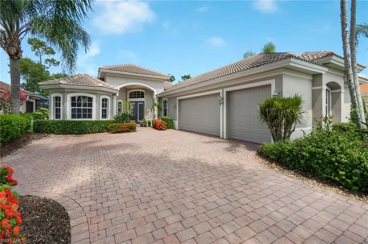 Mediterranean / spanish-style home with a garage