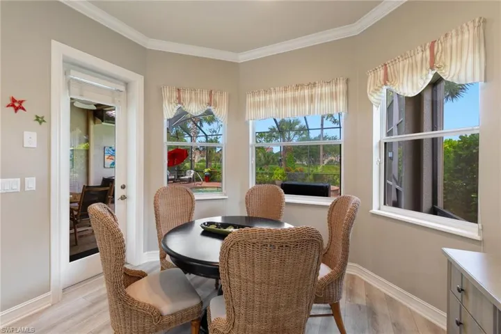 Dining area featuring ornamental molding and light wood-type flooring