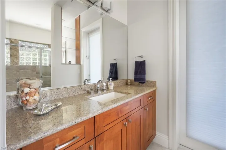 Bathroom with vanity and a shower with shower door