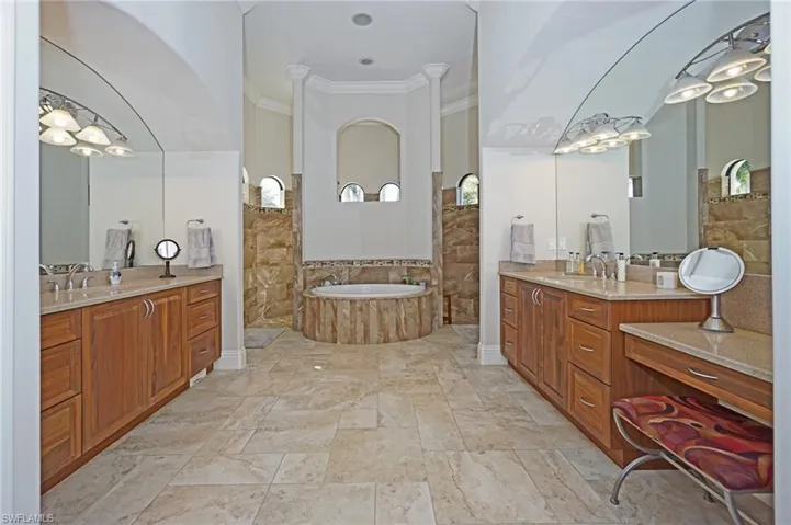 Bathroom with shower with separate bathtub, vanity, and ornamental molding