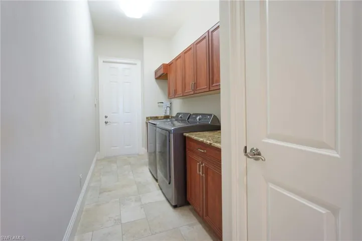 Laundry area with cabinets and separate washer and dryer