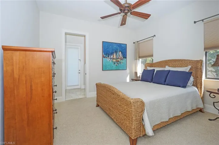 Carpeted bedroom with ceiling fan