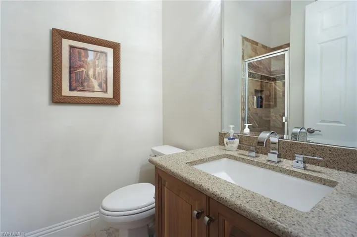 Bathroom with walk in shower, vanity, and toilet