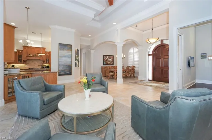 Living room with ornate columns and ornamental molding