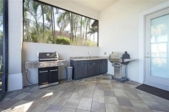 View of patio with sink and a grill
