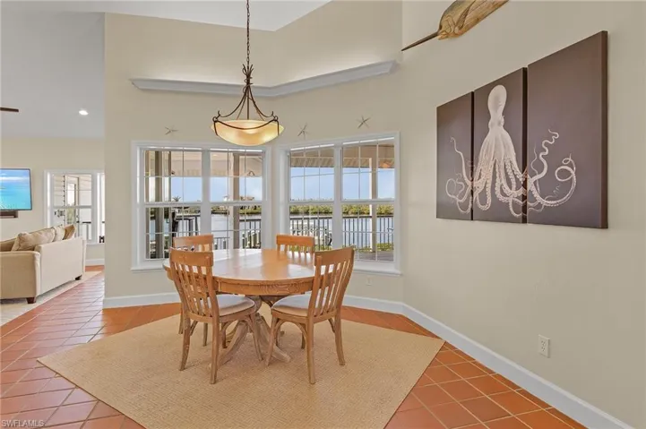Tiled dining space with a high ceiling