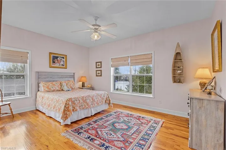 Bedroom with ceiling fan and wood-type flooring