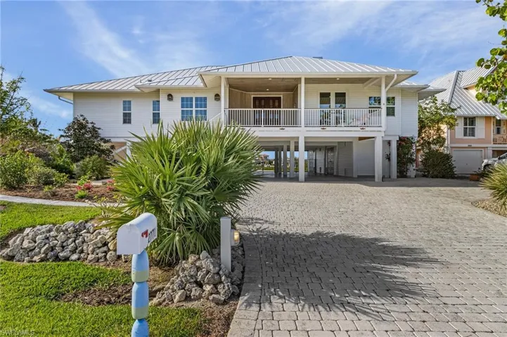 View of front facade featuring a carport and covered porch