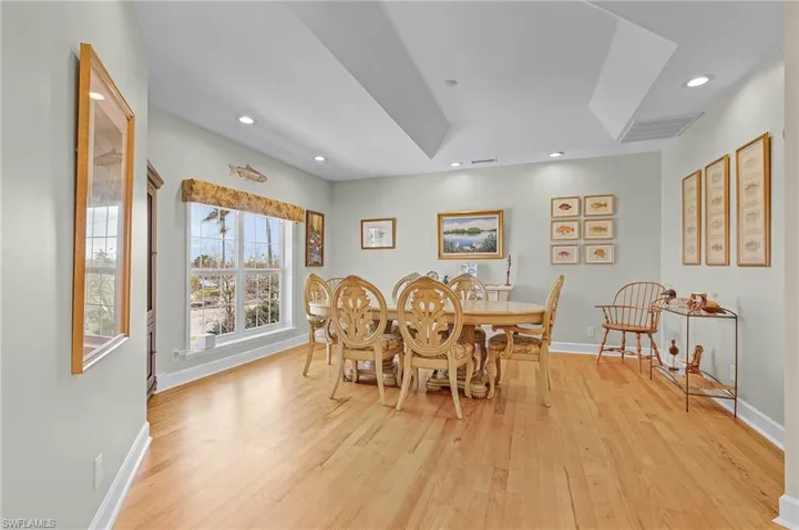Dining space featuring light hardwood / wood-style floors and a tray ceiling