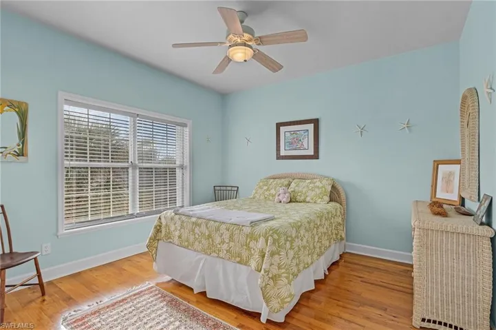 Bedroom with wood-type flooring and ceiling fan