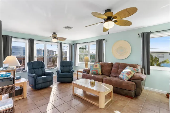 Tiled living room featuring ceiling fan