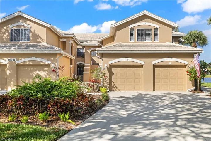 View of front of house with a garage, stucco siding, concrete driveway, and a tiled roof