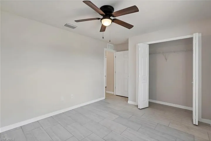 Unfurnished bedroom featuring a closet and ceiling fan