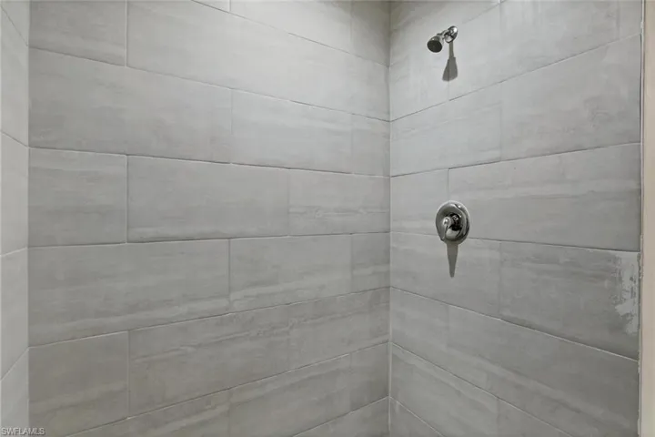 Room details with a tile shower