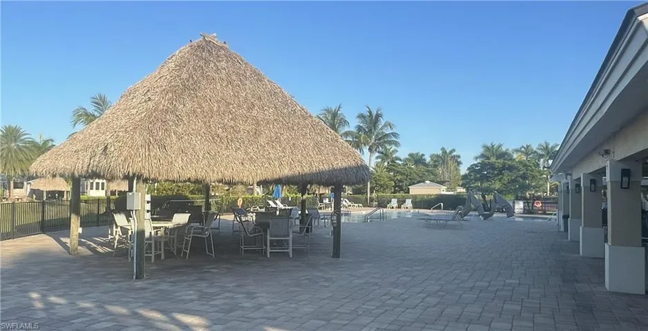 View of property's community featuring a swimming pool, a patio, and outdoor dining area