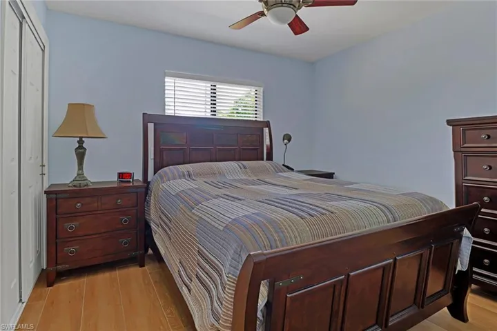 Bedroom with ceiling fan, a closet, and light hardwood / wood-style floors