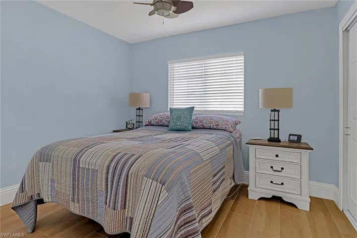 Bedroom featuring wood-type flooring and ceiling fan