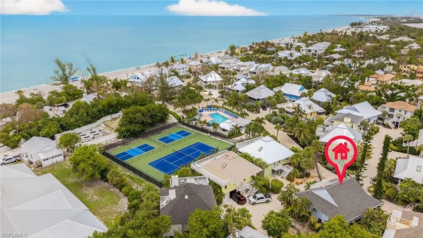 Aerial view of residential area with a large body of water and a pool area