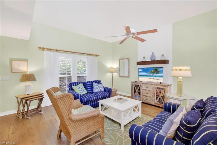 Living area featuring a ceiling fan and wood-type flooring